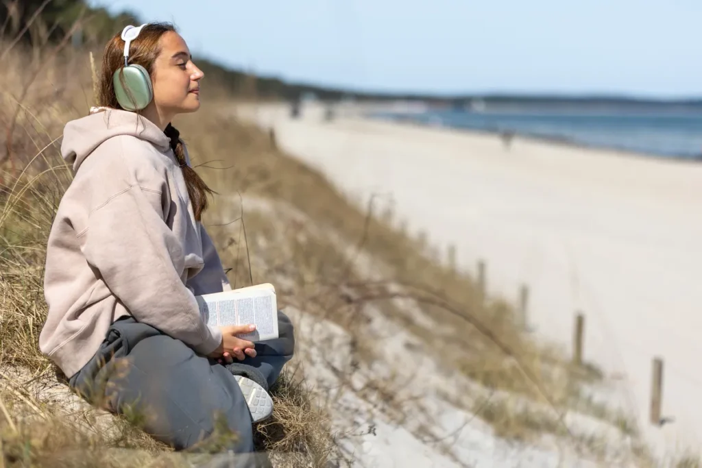 Woman sitting by the beach reflecting on ADHD, self-doubt and self-understanding