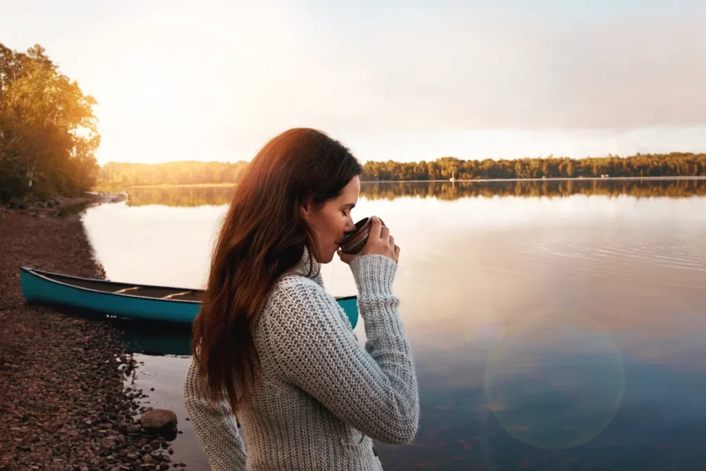 Woman reflecting outdoors at sunset while exploring feelings of anger, stress and overwhelm