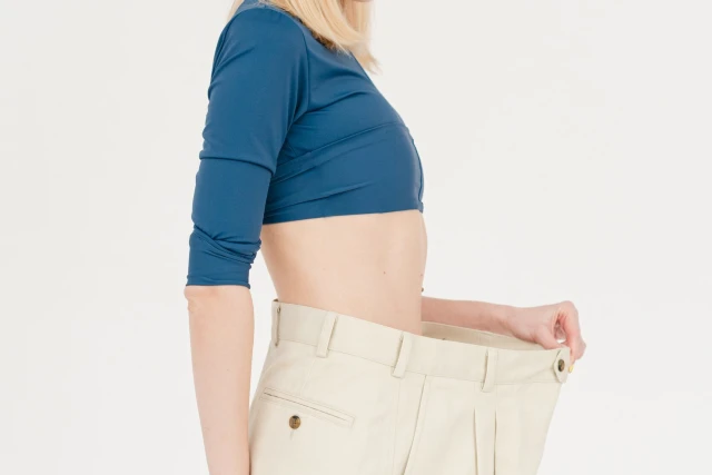 Woman showing weight loss signifying the benefits of weight control hypnosis