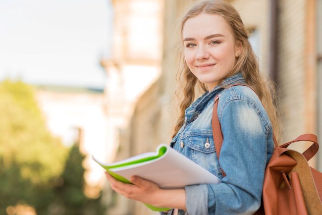 University student with ADHD holding a folder, symbolizing effective daily planning and organisation strategies