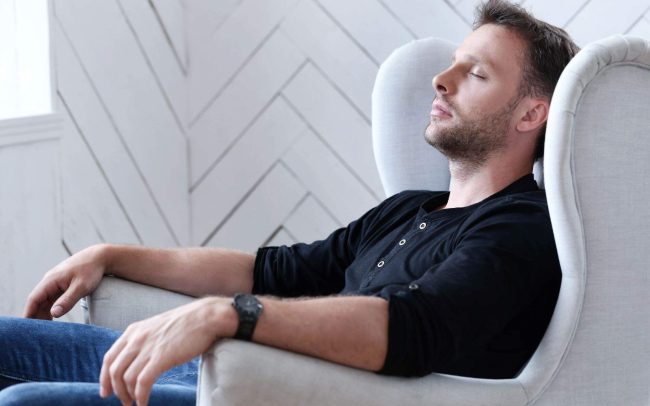 Man relaxing on a chair, illustrating Life Transitional Therapy and Coaching RTT at Clear Haven Therapy