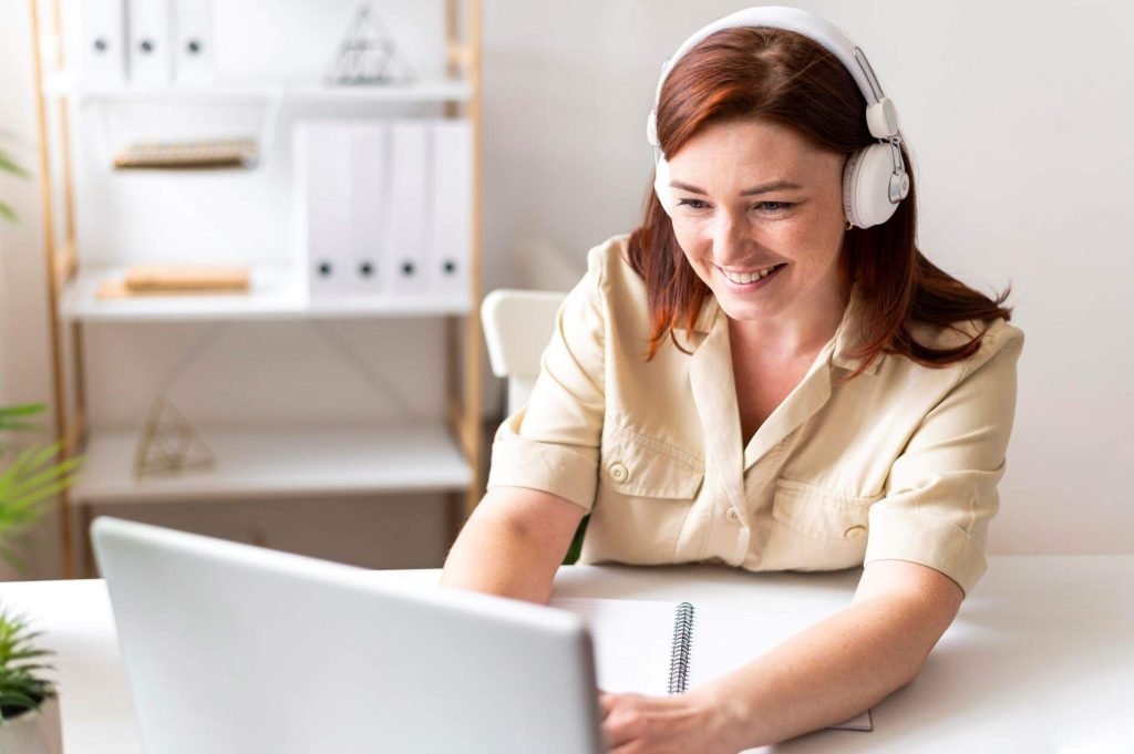 A woman on her laptop receiving ADHD coaching online