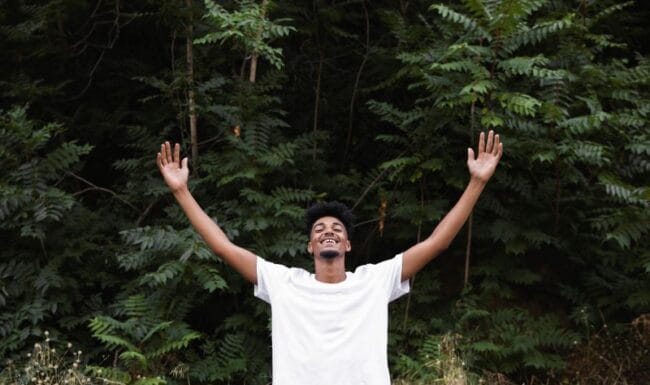 man with arms outstretched representing freedom from feelings of shame