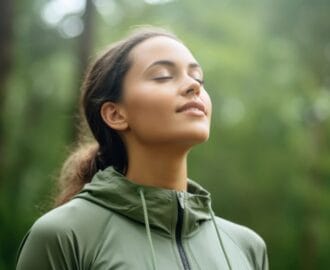 woman walking in the forest breathing in fresh air representing grounding exercises
