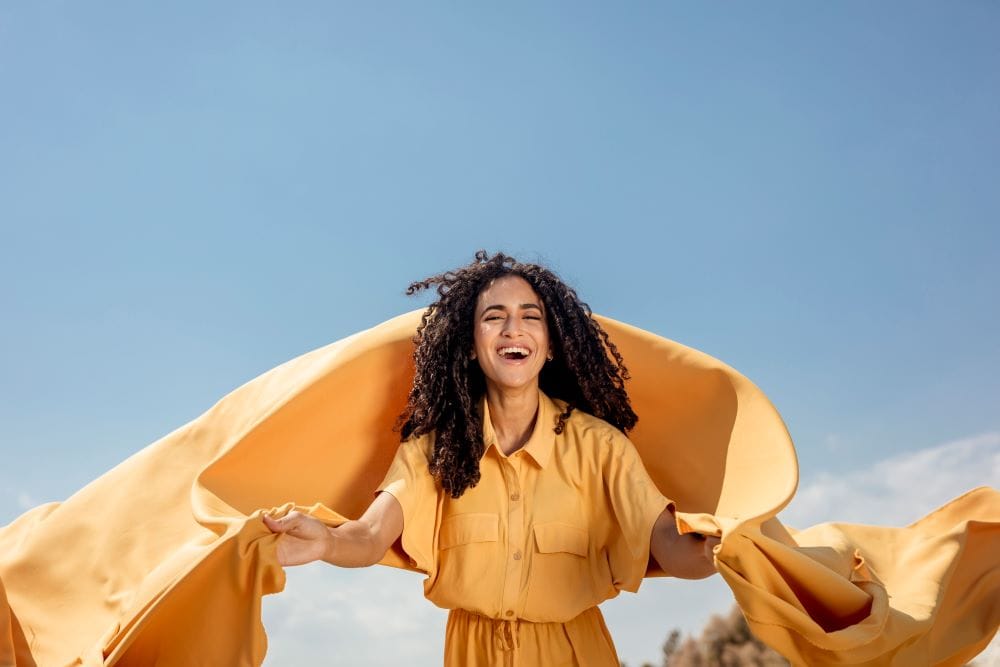 Self-Hypnosis for Stop Procrastinating Woman in nature with a yellow scarf representing self-hypnosis for stop procrastinating