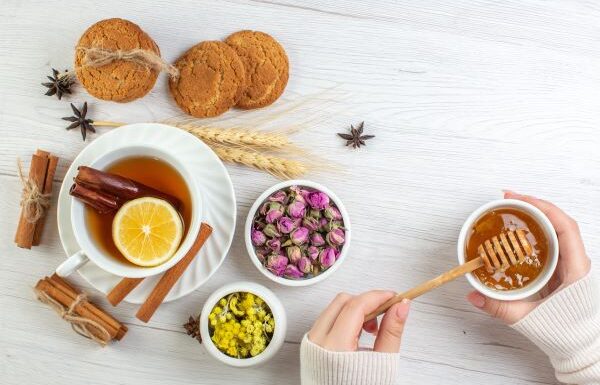 woman's hand round a cup drinking a healthy herbal tea