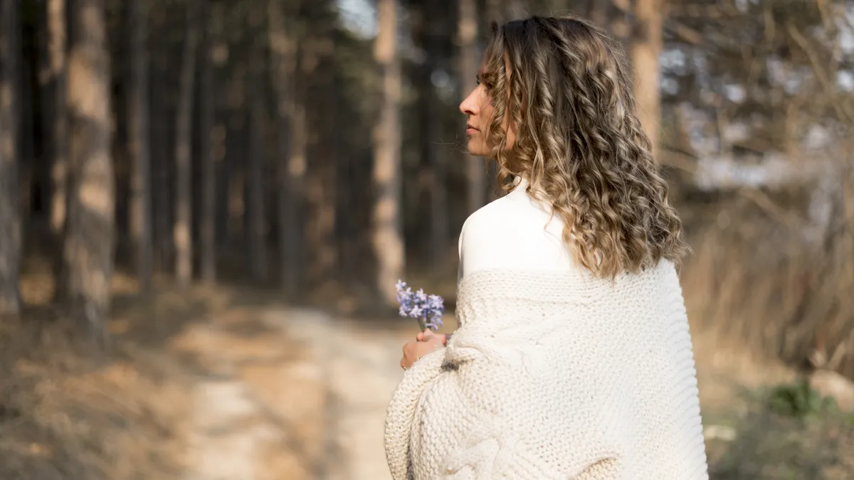 Woman reflecting in a woodland setting while coping with relationship anxiety and overthinking