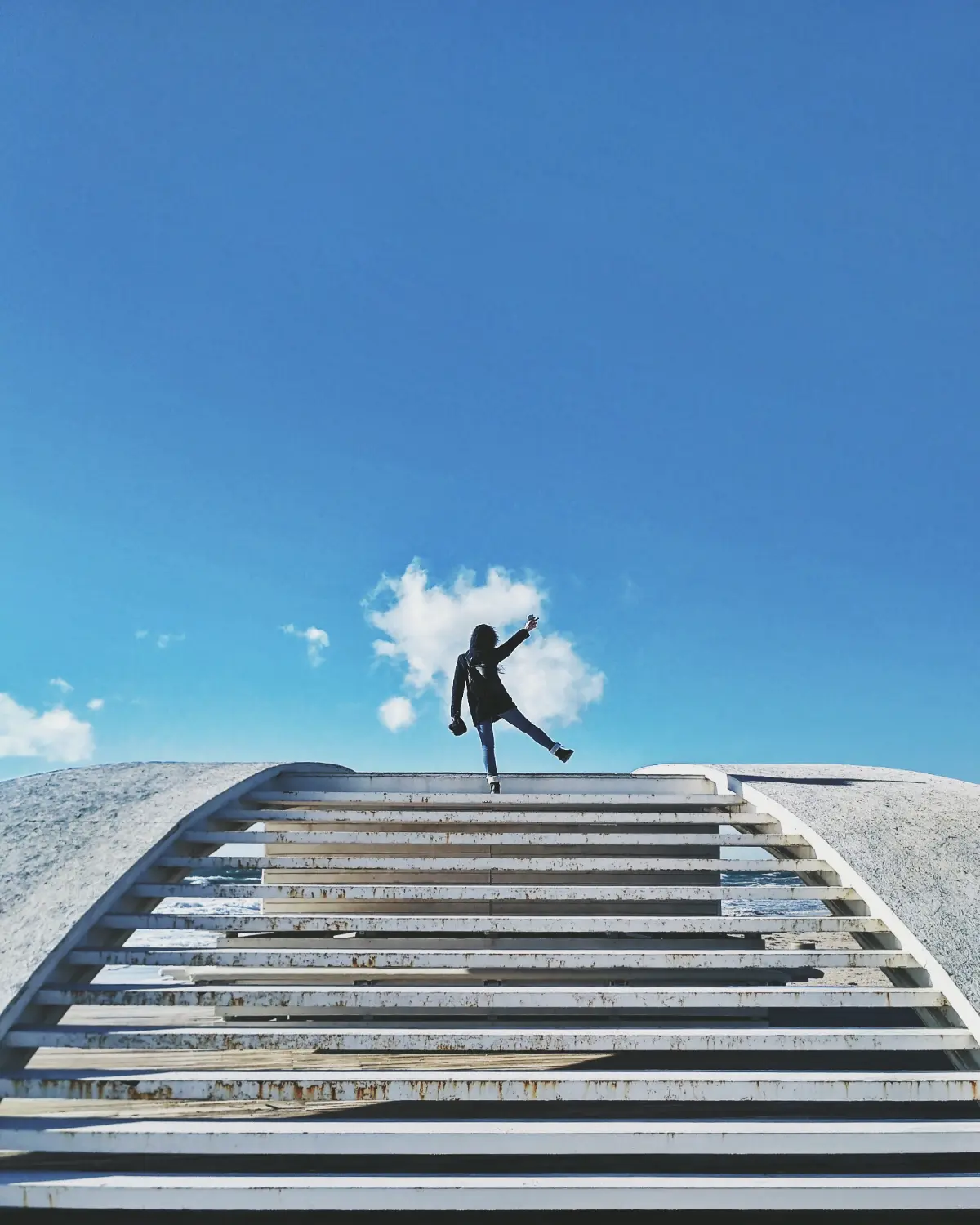 Person climbing steps outdoors representing progress and personal growth