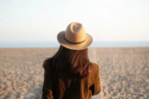 Woman looking out to sea while reflecting on physical anxiety and nervous system symptoms