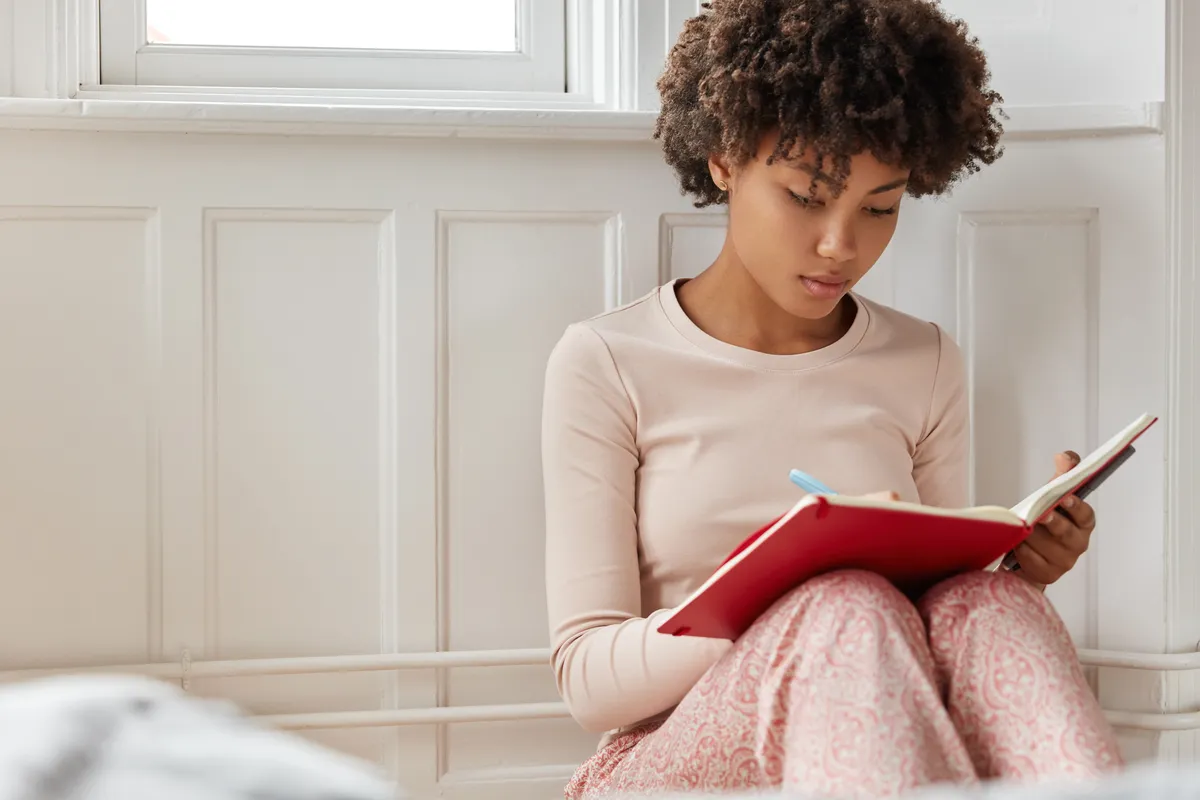 Woman journalling and practising self-compassion with ADHD