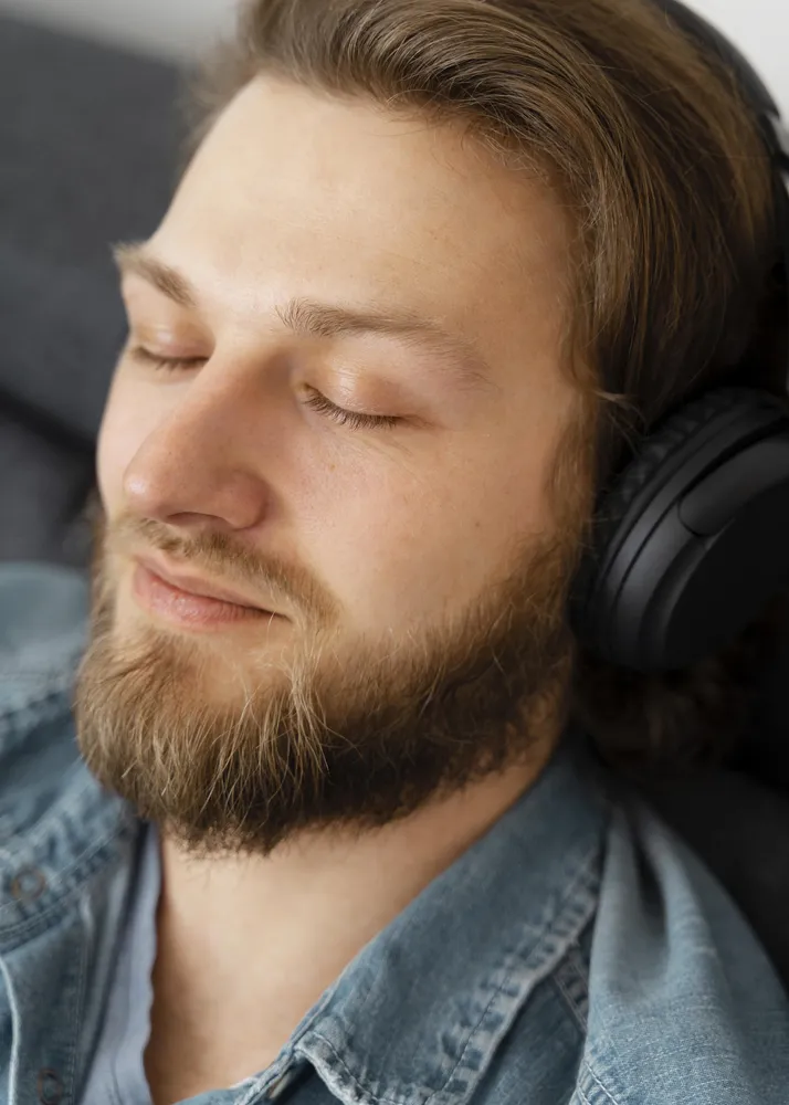 A man relaxing with headphones, representing the personalised audio recording provided as part of transformational therapy at Clear Haven Therapy