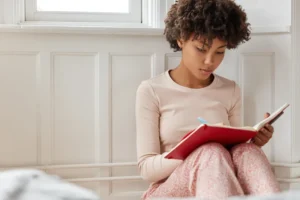 Woman journaling and practising self-compassion