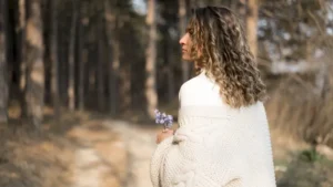 Woman reflecting in a woodland setting while coping with relationship anxiety and overthinking