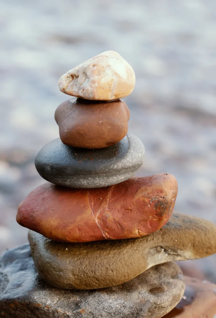 Balanced stack of stones representing steady progress and building lasting change.