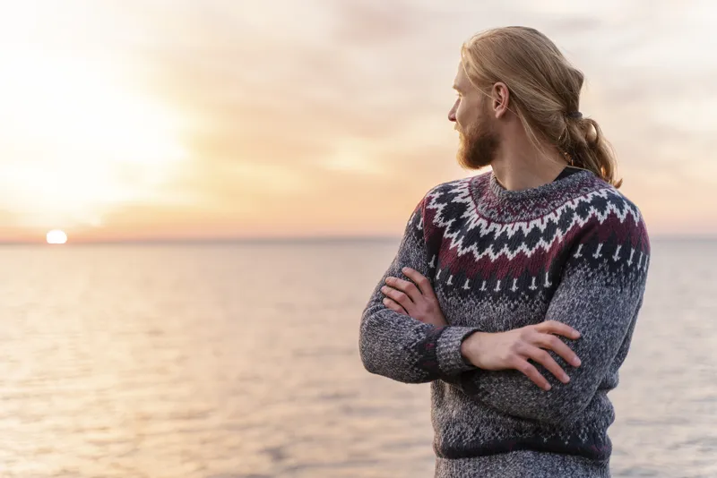 Man enjoying a quiet moment by the sea after feeling drained around people